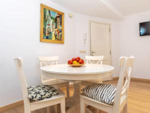 a white dining room table with a bowl of fruit on it at Apartment Gregal by Interhome in Tossa de Mar