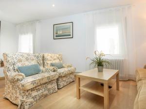 a living room with a couch and a table at Apartment Gregal by Interhome in Tossa de Mar +16 photos