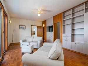 a living room with white furniture and a ceiling fan at Holiday Home Robert by Interhome in Trogir +20 photos