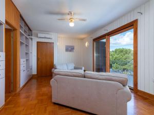 a living room with two couches and a large window at Holiday Home Robert by Interhome in Trogir