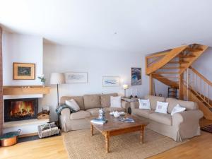 a living room with a couch and a fireplace at Apartment Matin Calme by Interhome in Chesières