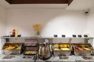 a kitchen with trays of food on a counter at Milli&Jon SPA in Bukovel