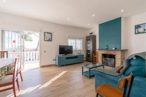 a living room with a blue couch and a fireplace at Kalacandi in Cunit