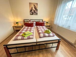 a bedroom with two beds with towels on them at Holiday Home Habichtnest by Interhome in Hörnitz