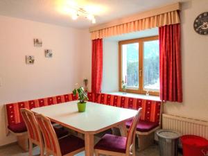 a dining room with a table and chairs and a window at Apartment Winklerhof - Bergblick by Interhome in Oetz