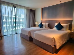 a hotel room with two beds and a large window at Super Studio La Vita 2 pool in Rawai Beach +27 photos