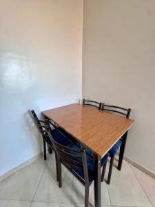 a wooden table and two chairs in a room at RENTSUITE SPACIOUS and COMFY 2 BEDROOM in Marrakech