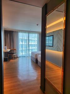 a hotel room with a bed and a large mirror at Super Studio La Vita 2 pool in Rawai Beach