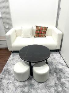 a living room with a table and a white couch at Vinhomes Ocean Park , Gia Lâm , Hà Nội in Gia Lâm Pho +1 photo