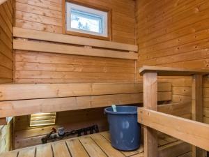 a log cabin with a bucket in the corner at Holiday Home Kylpylän ullanrinne 12 d by Interhome in Ikaalinen +8 photos