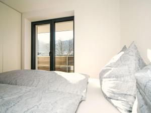 a bedroom with a bed and a window at Apartment Wibmer by Interhome in Axams