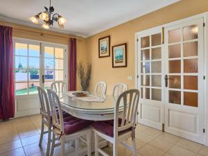 a dining room with a table and chairs at Holiday Home Villa Tos by Interhome in Sa Coma