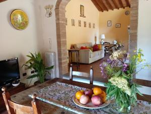 a living room with a table with fruit on it at Podere Casato 2 Hills View, Pool, Wifi Tuscany in Montespertoli