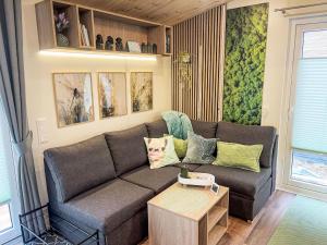 a living room with a couch and a table at Holiday Home Tiny Haus Tiny Moments by Interhome in Wemding