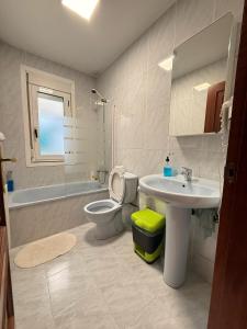 a bathroom with a sink and a toilet and a sink at Apartamentos Portolux in Portomarin +77 photos