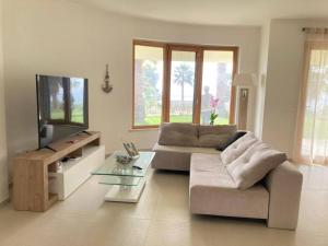a living room with a couch and a flat screen tv at Villa Jolanda - Costa degli Dei in Zambrone