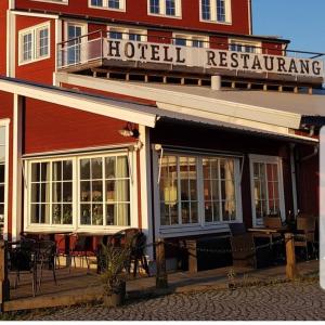 a hotel with tables and chairs in front of a building at Hotell Nostalgi in Motala