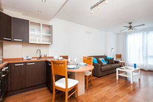a kitchen and living room with a table and a couch at Corralejo Main Street Apartment in Corralejo