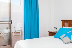 A bed or beds in a room at Corralejo Main Street Apartment