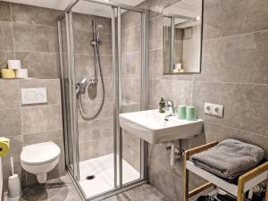 a bathroom with a shower and a sink and a toilet at Apartment Venet by Interhome in Wenns