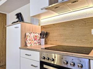 a kitchen with a stove and a refrigerator at Apartment Venet by Interhome in Wenns