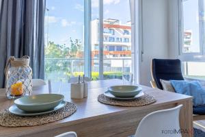 a dining room table with two bowls on top of it at Oliva Cozy Apartment in Oliva