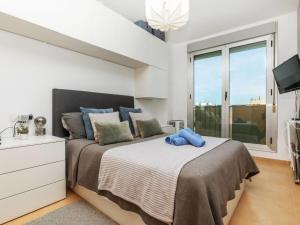 a bedroom with a large bed and a tv at Apartment Maxxie by Interhome in Benicarló