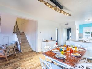 a kitchen and dining room with a table and chairs at Holiday Home Le Rayolet Parc by Interhome in Six-Fours-les-Plages