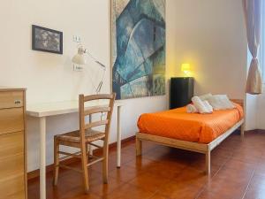 a bedroom with a bed and a desk and a chair at LOVELYLOFT, via Meda in Milan