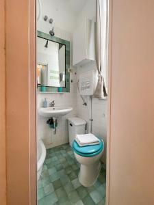 a bathroom with a blue toilet and a sink at LOVELYLOFT, via Meda in Milan +35 photos