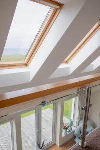 a skylight in a house with windows at Holiday Home Orral Cottage by Interhome in Kilmuir