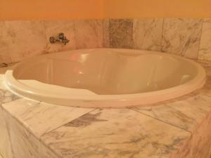 a bath tub sitting in the middle of a bathroom at Hotel Marimba Punta Cana in Punta Cana