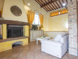 a living room with a couch and a fireplace at Holiday Home La Vecchia Pieve by Interhome in Nebbiano