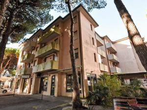 a building with palm trees in front of it at Apartment Antony by Interhome in Rosapineta