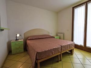 a bedroom with a bed and a lamp on a table at Apartment Solmare-52 by Interhome in Rosapineta +17 photos