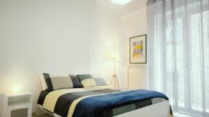 a bedroom with a bed and a large window at Misve Home in Cosenza