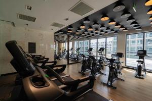 a gym with rows of treadmills and elliptical machines at Căn Hộ 2 Phòng Ngủ LUXURY 2502 in Gia Lâm Pho +10 photos