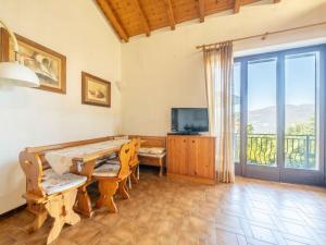 a dining room with a table and a television at Holiday Home Marzia by Interhome in Germignaga +31 photos