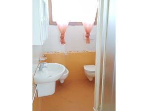 a bathroom with a sink and a toilet and a window at Berta in Rosolina +40 photos