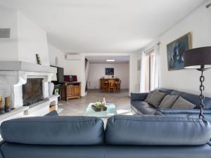 a living room with a blue couch and a fireplace at Villa Villa Bellevue by Interhome in Saint Paul de Vence