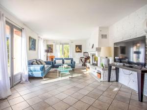a living room with a blue couch and a fireplace at Villa Villa Bellevue by Interhome in Saint Paul de Vence +23 photos