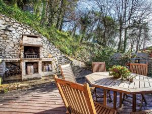 a wooden table and chairs with a stone fireplace at Villa Villa Bellevue by Interhome in Saint Paul de Vence
