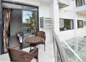 a balcony with a table and two chairs at 717 Cesar Place Hotel in Tagbilaran City