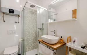a white bathroom with a sink and a shower at Beachfront Villa Tempera with Seaview in Blato +24 photos