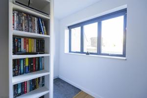 a window in a room with books at Pitts Cottage Annexe in Bladon