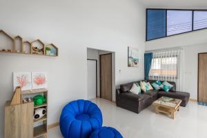a living room with a couch and a table at Mada pool villa near Aonang beach in Ban Chong Phli