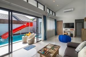 a living room with a slide and a pool at Mada pool villa near Aonang beach in Ban Chong Phli