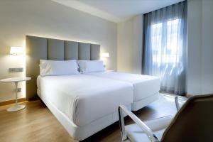 Ein Bett oder Betten in einem Zimmer der Unterkunft Hesperia Murcia Centro