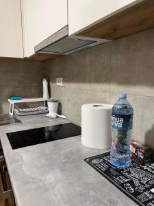 a bottle of water sitting on a counter in a kitchen at Golden Lux Apartments in Skopje