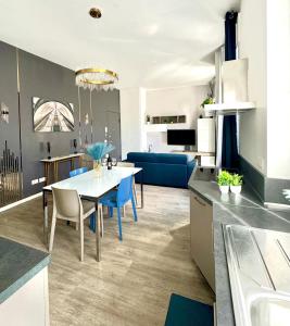 a kitchen and living room with a table and a couch at Milano Duomo Design Apartment in Milan